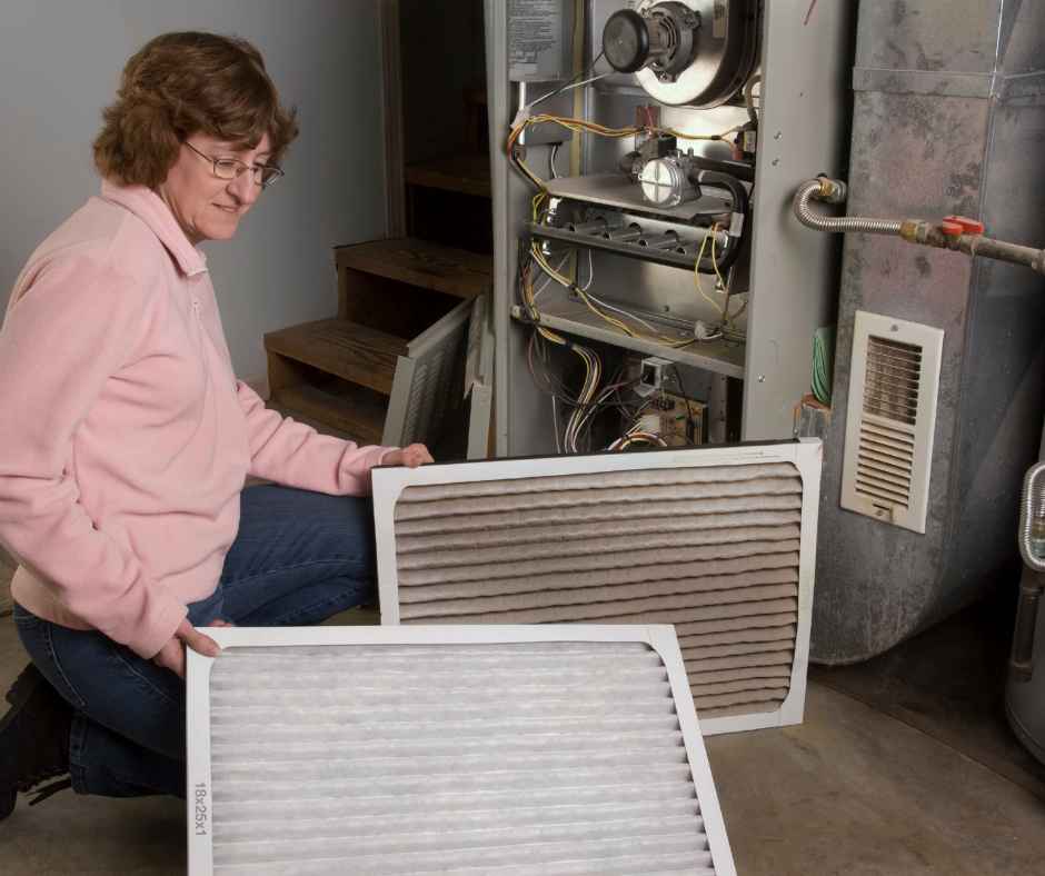 A woman changing her furnace filter