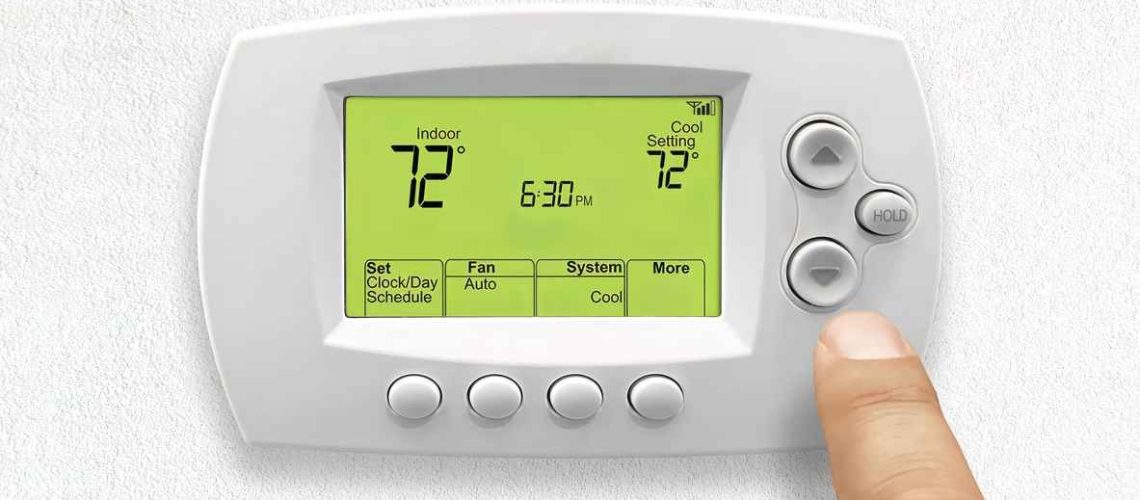 A person using a Home 7 Day Programmable Thermostat